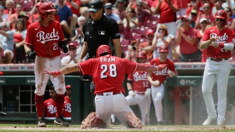 Tommy Pham, of the Reds, scores on a bases-clearing double by Tyler Stephenson in the second inning on Wednesday, May 11, 2022, at Great American Ball Park in Cincinnati. David Jablonski/Staff