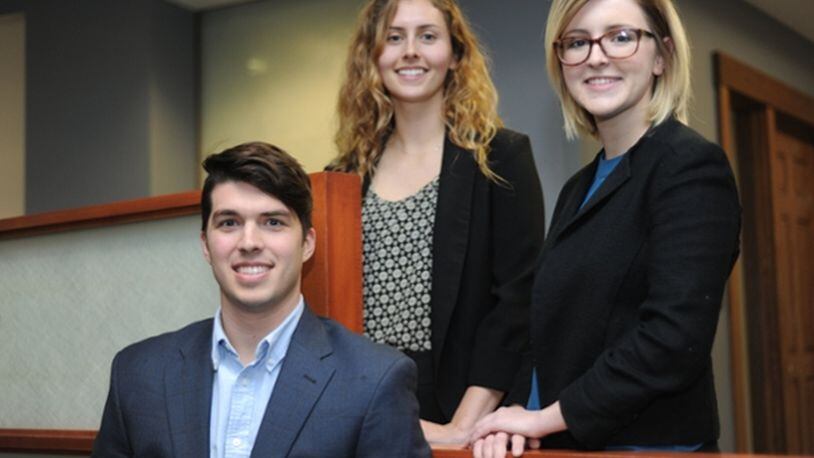 University of Dayton students John Seals, Lauren Wolford, left, and Colleen Sullivan, right, will compete in a global digital marketing competition hosted by Unilever in January. The students developed a social media campaign using Talenti brand gelato containers.