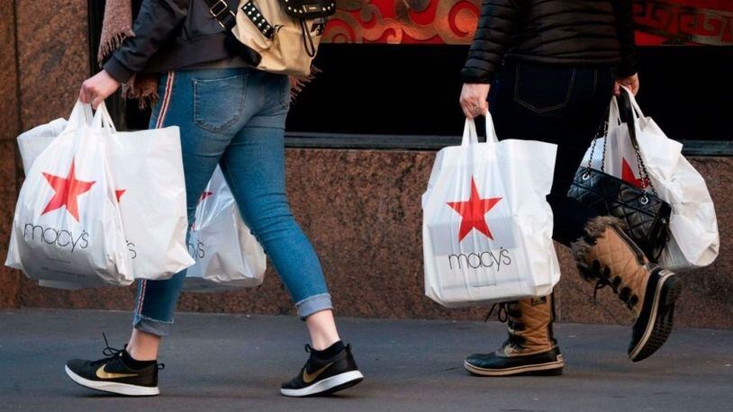 Shoppers walk outside the Macy's store at Manhattan's Herald Square in New York. Photo by Don EMMERT / AFP/Getty Images.
