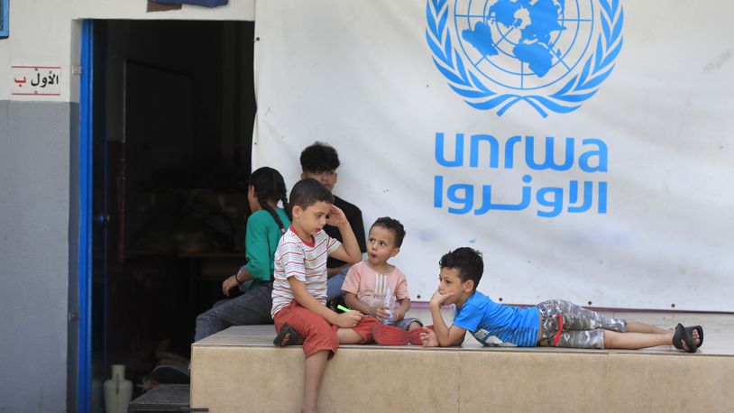 FILE - Palestinian children who fled with their parents from their houses in the Palestinian refugee camp of Ein el-Hilweh, gather in the backyard of an UNRWA school, in Sidon, Lebanon, Sept. 12, 2023. An independent review released Monday, April 22, 2024, of the neutrality of UNRWA, the U.N. agency helping Palestinian refugees, has found that Israel never expressed concern about anyone on the staff lists it has received annually since 2011. The review was carried out after Israel alleged that a dozen employees of the agency had participated in Hamas’ Oct. 7 attacks. (AP Photo/Mohammed Zaatari, File)
