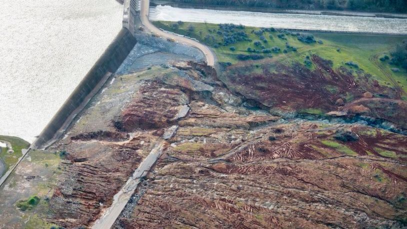 In an aerial photo, the emergency spillway at Lake Oroville shows signs of damage from the water which spilled over recently, on Monday, Feb. 13, 2017, in Oroville, Calif. Sunday afternoon's evacuation order came after engineers spotted a hole on the concrete lip of the secondary spillway for the 770-foot-tall Oroville Dam and told authorities that it could fail within the hour.  (Randy Pench/The Sacramento Bee via AP)