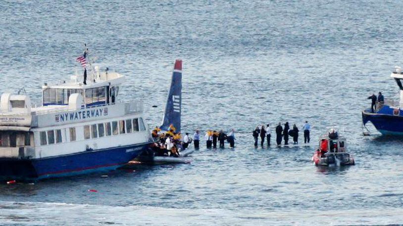 In this Jan. 15, 2009, file photo, passengers stand on the wing of a US Airways jetliner waiting to be rescued by ferry boats that rushed to the plane in the Hudson River in New York.