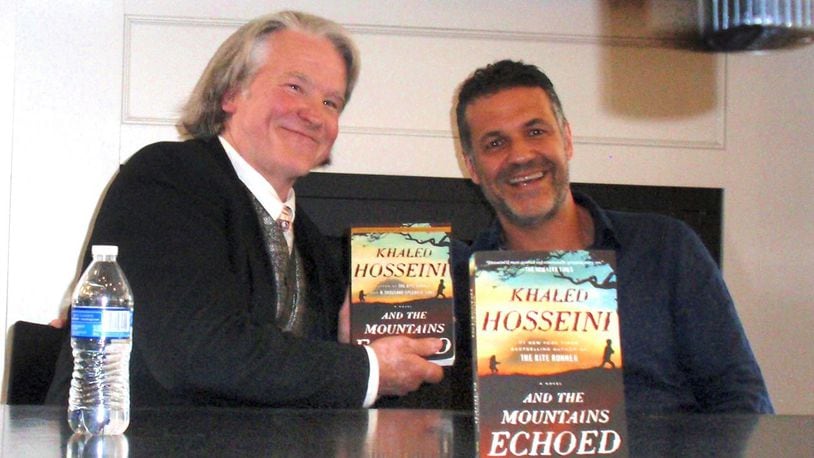 Vick Mickunas, left, with the novelist Khaled Hosseini at Books and Co. in Beavercreek. Hosseini is one of many authors Mickunas has interviewed on the journey to his 1,000th book column. CONTRIBUTED