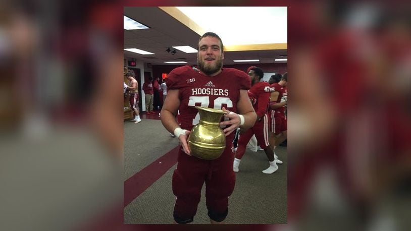 Wes Martin holds the golden spittoon after an Indiana victory over Michigan State. The two teams play for the rites of the golden spittoon trophy each time the meet. CONTRIBUTED