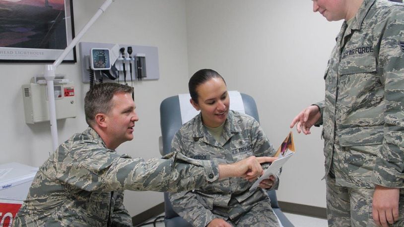 Maj. Justin Fox, 88th Medical Group plastic surgeon, and medical technician Senior Airman Leah Borland, discuss plastic surgery options with Airman 1st Class Brittany Hartsock (middle). The 88th Medical Group plastic surgery clinic’s primary mission is to provide reconstructive procedures but also offers cosmetic procedures. (U.S. Air Force photo/Stacey Geiger)