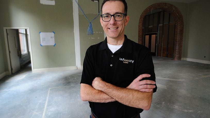 Harry Panson Jr., Program & Product Manager, for Infinity Labs stands in the expanded offices that are under construction at 15 W. 4th Street, in downtown Dayton.  MARSHALL GORBY\STAFF