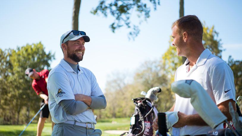 Wright State coach Conner Lash (left) talks to senior Bryce Haney during the Dayton Flyer Invitational in October at NCR Country Club. Joseph Craven/Wright State Athletics