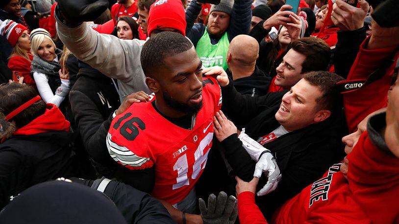 COLUMBUS, OH - NOVEMBER 26:   J.T. Barrett #16 of the Ohio State Buckeyes leaves the field after defeating the Michigan Wolverines at Ohio Stadium on November 26, 2016 in Columbus, Ohio.  (Photo by Gregory Shamus/Getty Images)
