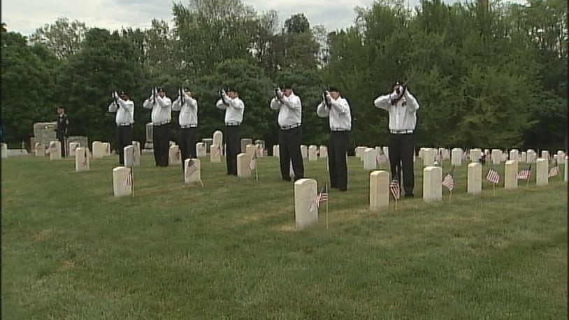 An honor squad conducts a 21-gun salute during Memorial Day services at Dayton National Cemetery. STAFF/ ERIC HIGGENBOTHAM
