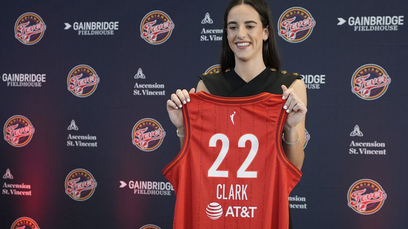 Indiana Fever's Caitlin Clark holds her jersey following a WNBA basketball news conference, Wednesday, April 17, 2024, in Indianapolis. (AP Photo/Darron Cummings)