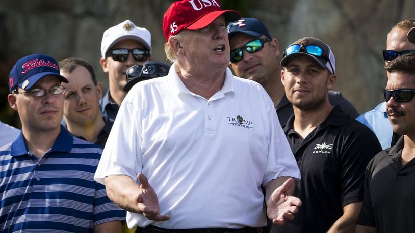 President Donald Trump with Coast Guard service members at his Trump National Golf Club in West Palm Beach, Fla., Dec. 29, 2017. About 60 service members participated in a four-man scramble tournament here Friday. (Al Drago/The New York Times)