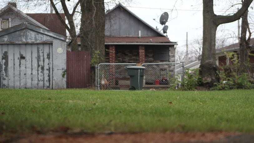 A vacant residential property in east Dayton that backs up to houses on an adjacent street. CORNELIUS FROLIK / STAFF