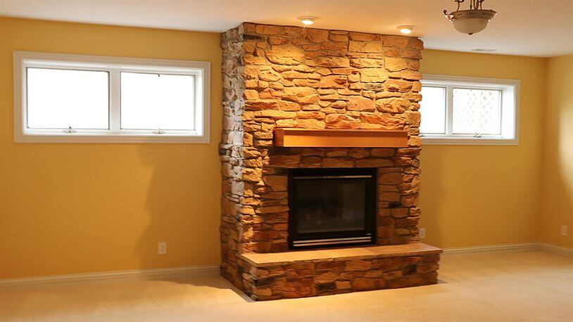 The lower level has been finished into a recreation room with a stone fireplace and kitchenette area, a media room, an exercise room and 2 bedrooms with above-ground windows and a full bathroom.