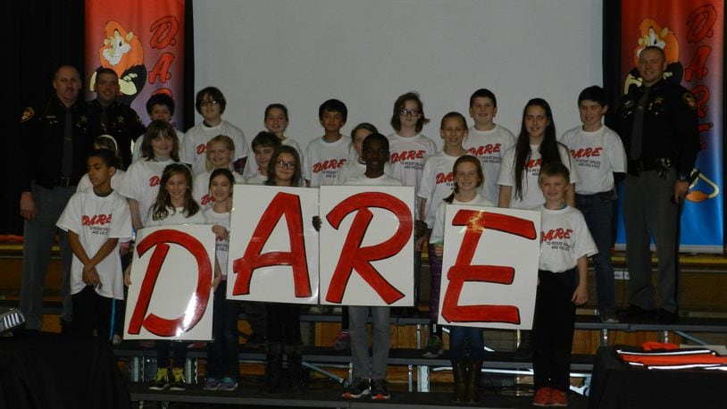 The Beavercreek Police Department wants to apply for a grant to help finance its DARE program for 2017-18. The DARE program is used in school districts nearly everywhere. In this photo fifth-grade students in the Clark-Shawnee Local School District display a DARE program related project. CONTRIBUTED