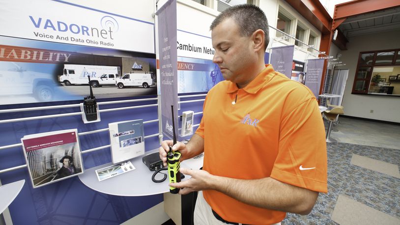 Chris Hanes, sales manager at P&R Communications Service, is seen with a new digital two-way radio used by the public safety sector. P&R representatives are in favor of the Marketplace Fairness Act that would require retailers to collect sales tax on online sales. CHRIS STEWART / STAFF