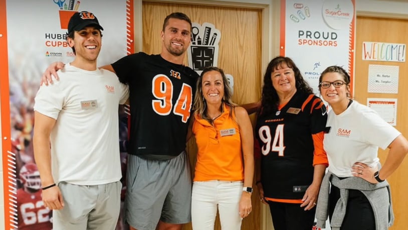 Cincinnati Bengals defensive End Sam Hubbard has The Sam Hubbard Foundation with the mission of tackling food insecurity in the Tri-State. Hubbard is seen here second from left. CONTRIBUTED