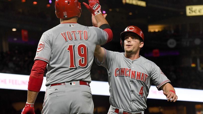 SAN FRANCISCO, CA - MAY 11:  Scooter Gennett #4 of the Cincinnati Reds is congratulated by Joey Votto #19 after Gennett scored against the San Francisco Giants in the top of the eighth inning at AT&T Park on May 11, 2017 in San Francisco, California.  (Photo by Thearon W. Henderson/Getty Images)