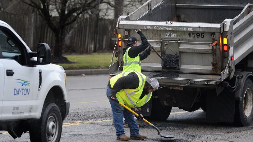 City of Dayton Street Maintenance crews fill potholes along Wilmington Ave. near Wayne Ave. Friday, Jan. 26, 2024. MARSHALL GORBY\STAFF