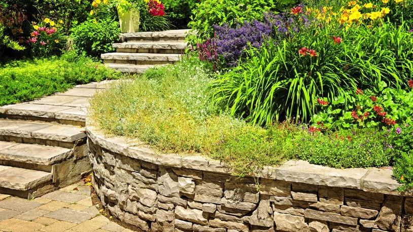 A stone retaining wall looks classic and natural particularly when it s installed by a skilled stonemason. (Dreamstime)