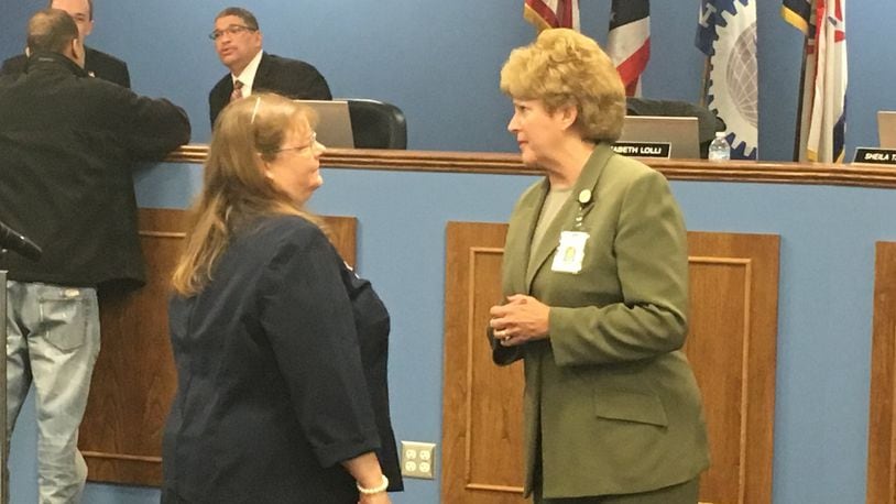 Dayton Public Schools Superintendent Elizabeth Lolli (right) talks to DPS Human Resources Director Judith Spurlock at a March 2018 school board meeting. The district is making significant changes to administrative staff this fall. JEREMY P. KELLEY / STAFF