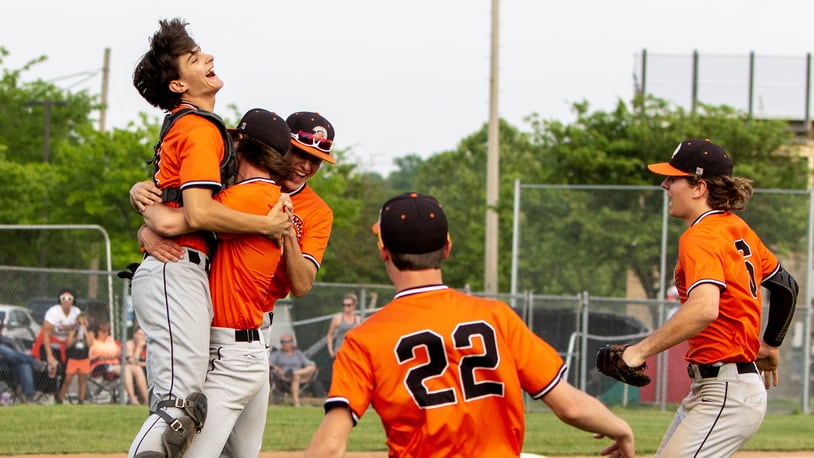 Waynesville pitcher Nate LeBlanc lifts catcher Peyton Frederick into the air as the Spartans celebrate Wednesday's 3-2 district final victory over Arcanum at Kings High School. Jeff Gilbert/CONTRIBUTED