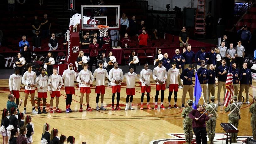 Dayton stands for the national anthem before a game against Massachusetts on Wednesday, Feb. 22, 2023, at the Mullins Center in Amherst, Mass. David Jablonski/Staff