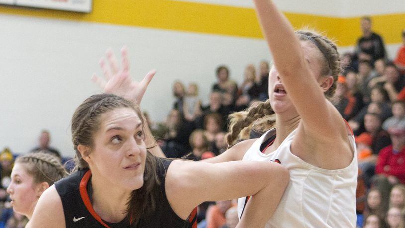 Versailles’ Danielle Winner looks to score against Waynesville’s Marcella Sizer during Saturday’s Division III regional final. Winner scored 11 points and Versailles won 59-28. JEFF GILBERT / CONTRIBUTED