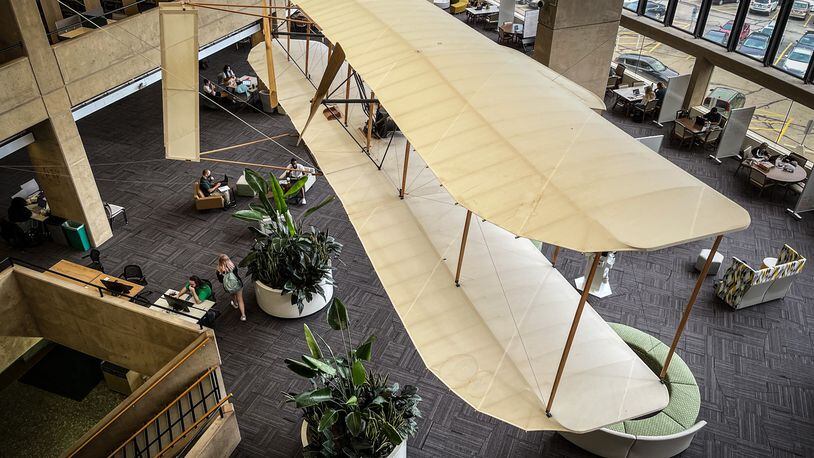A replica of the Wright Flyer hangs over the students at Wright State University library. JIM NOELKER/STAFF