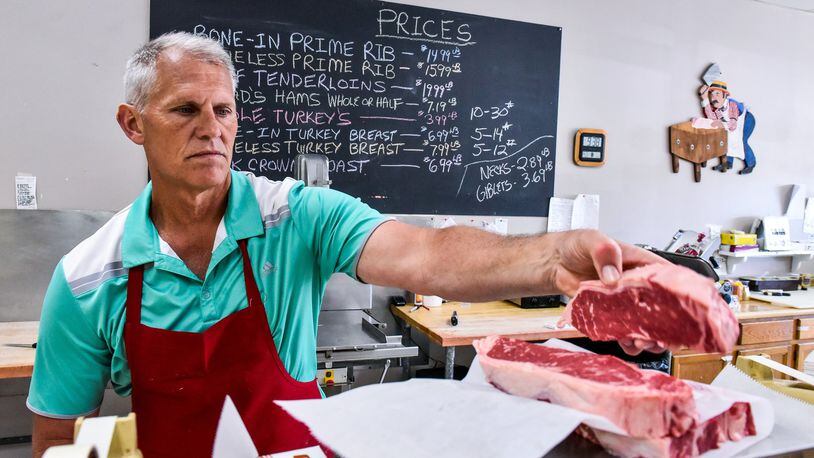 Steve Overberg, owner of Steve’s Meat & Deli in West Chester Twp., prepares an order of steaks for a customer Friday, May 25. Memorial Day weekend is the unofficial start of grilling season and is a major holiday that drives sales, including meat sales, at local grocery stores. NICK GRAHAM/STAFF