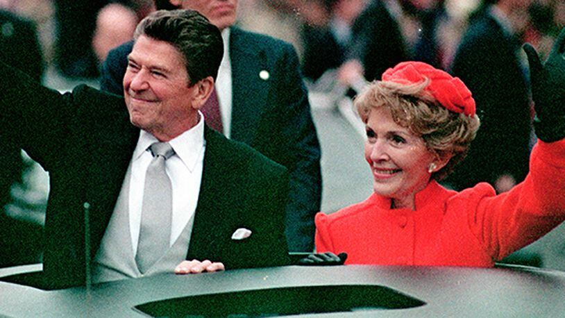 This Jan. 20, 1981 file photo, shows President Ronald Reagan as he gives a thumbs up to the crowd while his wife, first lady Nancy Reagan, waves from a limousine during the inaugural parade in Washington following Reagan's swearing in as the 40th president of the United States. Sunday, Feb. 6, 2011, marks the centennial anniversary of Reagan's birth.