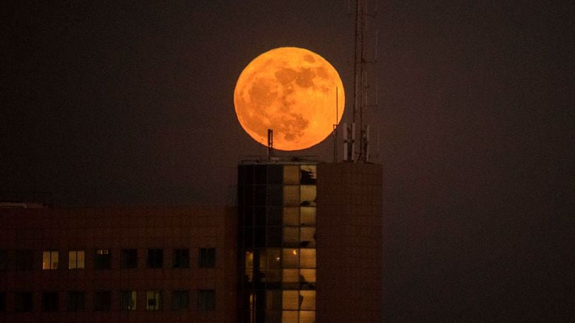 The supermoon rises over a building in the Israeli city of Netanya on Sunday.