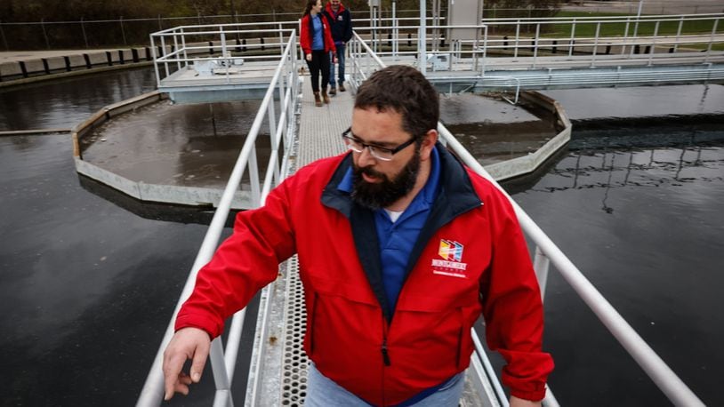 Montgomery County eastern regional water reclamation facility plant manager Donald Hartmen walks across the secondary clarifier on a catwalk at the plant on Spaulding Road Tuesday March 26, 2024. JIM NOELKER/STAFF