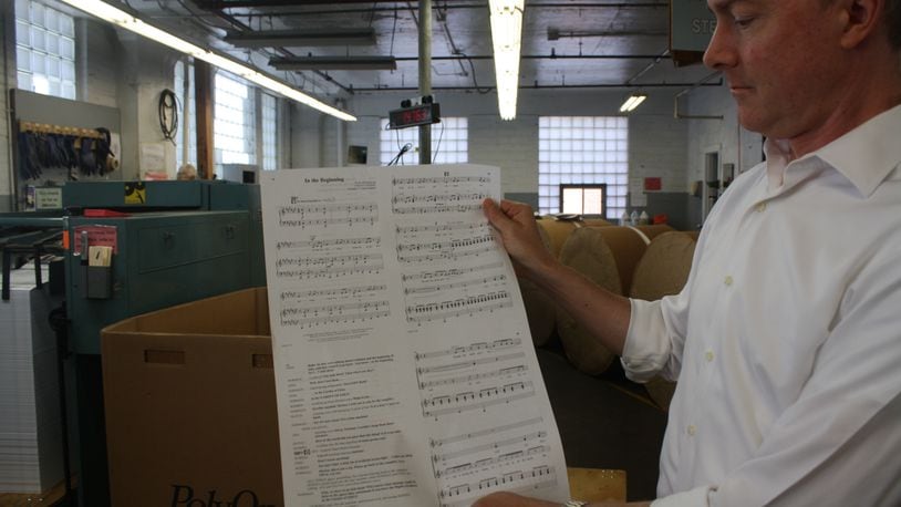 Reiff Lorenz, Lorenz Corp. chief executive, with sheet music produced by his company. The Lorenz Corp. is a fifth-generation family business that publishes sheet music in downtown Dayton at 501 E. Third St. KAITLIN SCHROEDER/STAFF