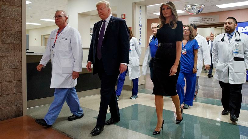 President Donald Trump and first lady Melania Trump walk with surgeon Dr. John Fildes, meeting with survivors of the mass shooting Wednesday, Oct. 4, 2017, in Las Vegas. (AP Photo/Evan Vucci)