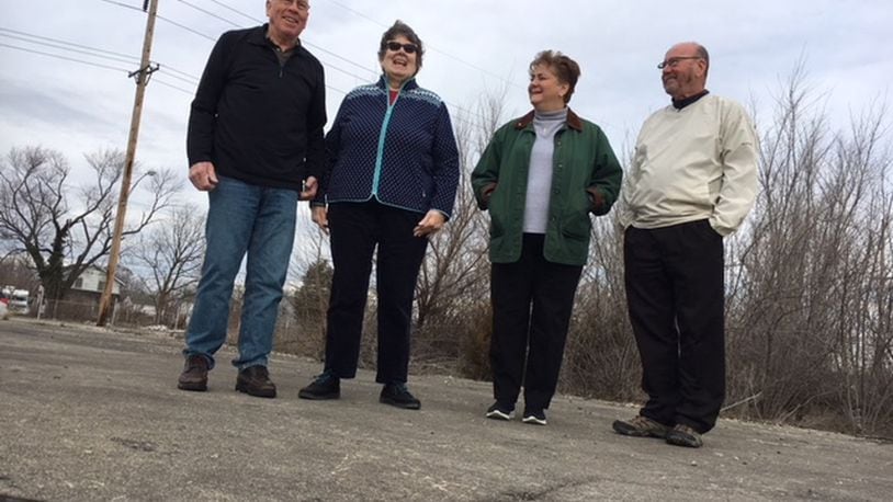 Dayton-area Delphi salaried retirees (from left), Tom Rose, Mary Miller, Marlane Bengry and Tom Green, standing on the foundation of the former Delphi Wisconsin Boulevard plant in Dayton. THOMAS GNAU/STAFF