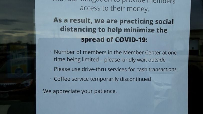 A notice to customers on the door of a local Wright-Patt Credit Union member center this week. VICKIE HARRIS/STAFF