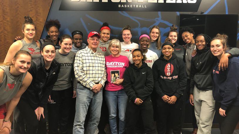 Donny and Pam Fortener surrounded by last season's Dayton Flyers women's team. CONTRIBUTED