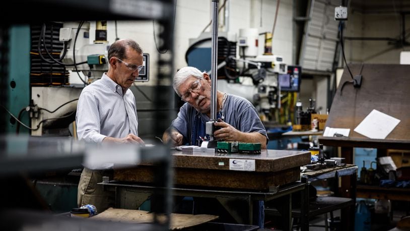 Jim Bowman, Noble Tool President and CEO, left works with tool maker and machinist, John Maxwell at the plant on Stanley Ave. in Dayton Friday Oct. 1, 2021. Bowman said he has less then 100 employees and he will not mandate the COVID-19 vaccine. JIM NOELKER/STAFF