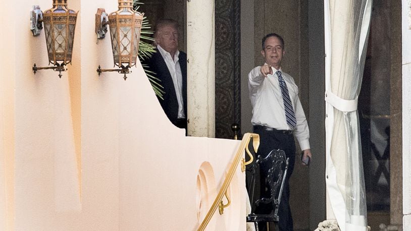 President-elect Donald Trump, left, and Trump Chief of Staff Reince Priebus, right, walk along a balcony at Mar-a-Lago resort, in Palm Beach, Fla., Monday, Dec. 19, 2016. Trump is taking meetings today at the resort. (AP Photo/Andrew Harnik)
