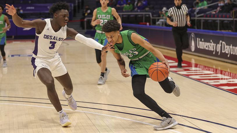 Chaminade Julienne High School freshman Jonathan Powell drives past Columbus St. Francis DeSales senior Obed Achirem during their Division II state semifinal game on Saturday afternoon at UD Arena. DeSales won 51-34. Michael Cooper/CONTRIBUTED