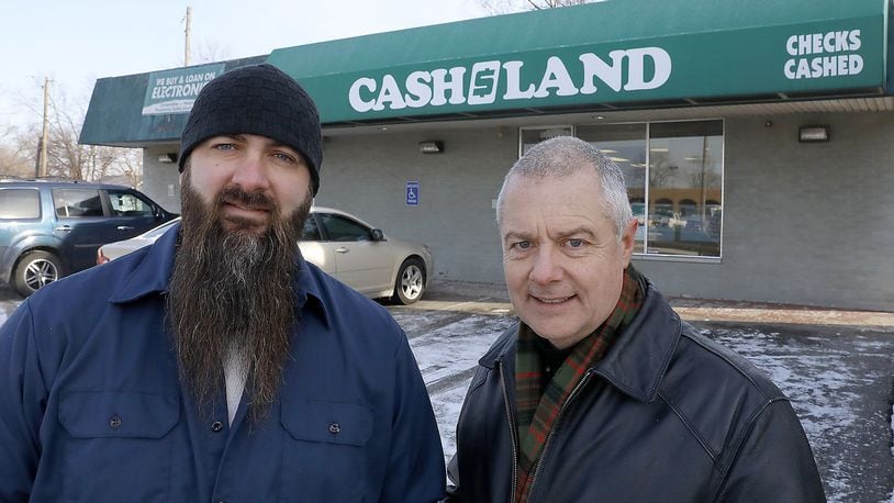 Carl Ruby, pastor of the Central Christian Church, right, and Derek Drewery, pator New Day Christian Fellowship, talk about the high interest rates at payday lenders in the Springifeld area. Bill Lackey/Staff