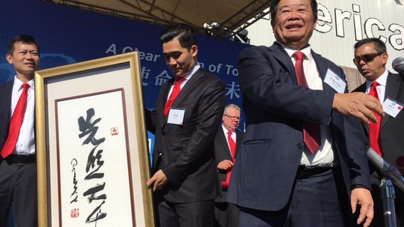 Cho Tak Wong, chairman of Fuyao Global — seen here to the right of a Chinese gift at the company’s October grand opening — estimated in 2016 that the Fuyao Glass America plant in Moraine could have 3,000 employees at some point, but he attached no timeline to that prediction. THOMAS GNAU/STAFF