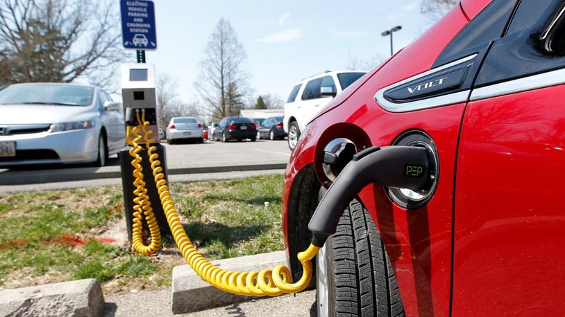 A Chevy Volt is hooked to an electric vehicle charging station on Miami University’s campus in this file photo.