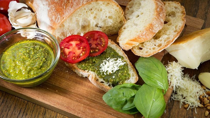 Fresh basil, pine nuts, garlic and olive oil are the main ingredients in fresh pesto. (Mike Siegel/Seattle Times/TNS)