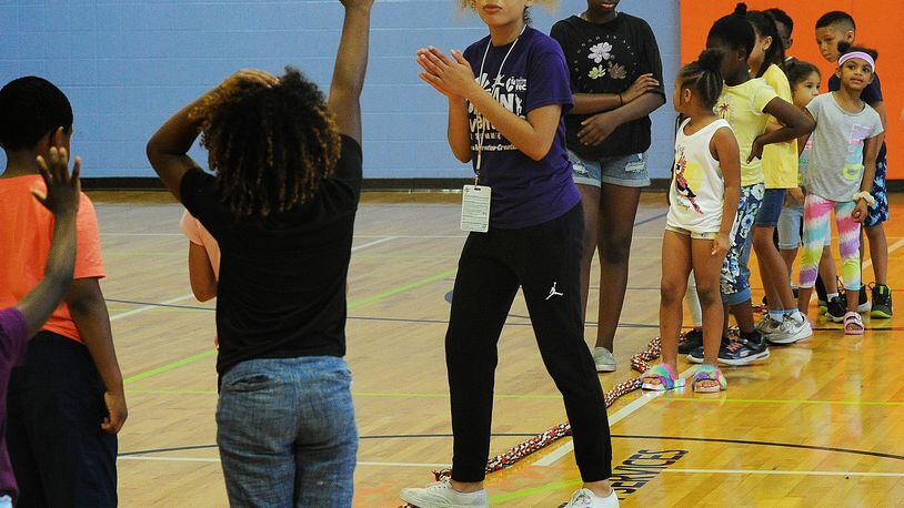 Lohrey Rec Center, summer camp staff member, Nevaeh McDonald, center, prepares camp members for a tug-of-war competition Wednesday, June 8, 2022. MARSHALL GORBY\STAFF