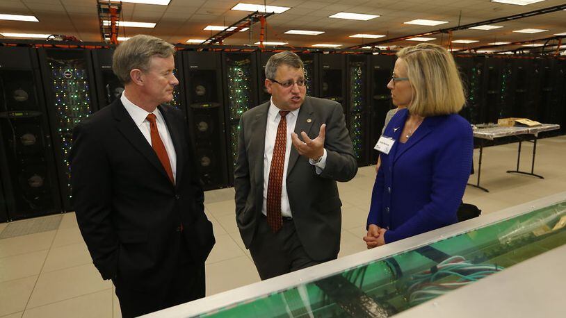 University of Texas System Chancellor Bill McRaven, left, gets a tour of the Texas Advanced Computing Center's new facilities on Thursday, June 2, 2016. Center is Dan Stanzione, executive director of the Texas Advanced Computing Center, and at right is ???