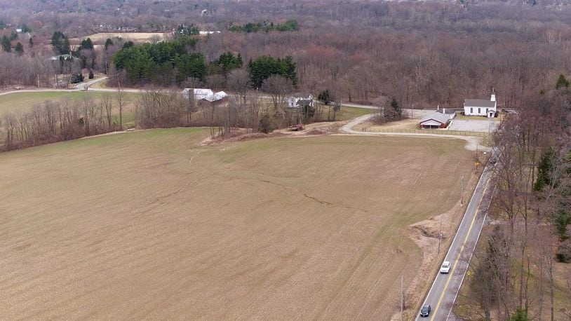 Aerial view looking north along Wilmington-Dayton Road and Conference Road in Sugarcreek Twp. Sugarcreek trustees may vote on whether to allow Oberer to build homes on 85 acres known as the Rammel property at this location. TY GREENLEES / STAFF