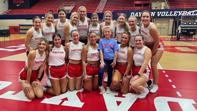 Six-year-old Parker Roche, a first grader at Anna Elementary School, with the Dayton Flyers cheerleaders during one of their practice sessions in the Frericks Center. CONTRIBUTED