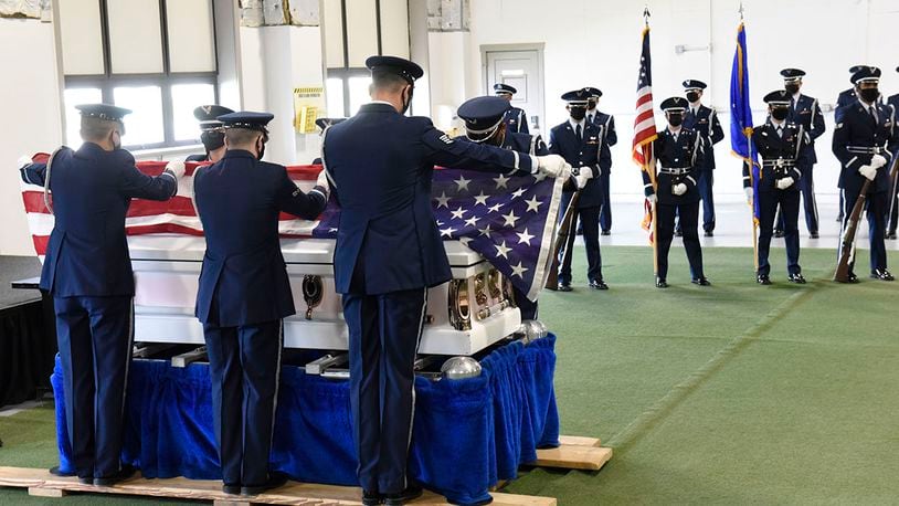 During the graduation ceremony of new Honor Guard members at Wright-Patterson Air Force Base on April 20, members the six-man flag fold over a casket. A 21-gun salute was also included before graduates received their Honor Guard badges. U.S. AIR FORCE PHOTO/TY GREENLEES