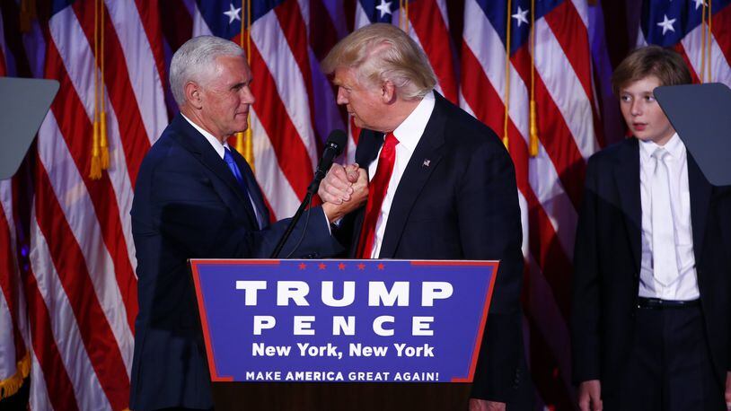President-elect Donald Trump clasps hands with his running mate, Mike Pence at his victory speech, around 3 a.m. in New York, Nov. 9, 2016. Trump said that he had received a phone call of congratulations from Hillary Clinton. (Eric Thayer/The New York Times)